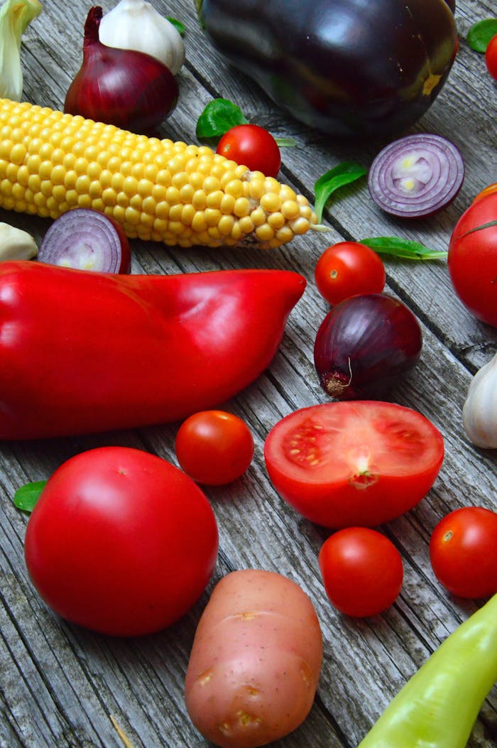 services-03 A vibrant assortment of fresh vegetables on a rustic wooden table, ready for cooking.